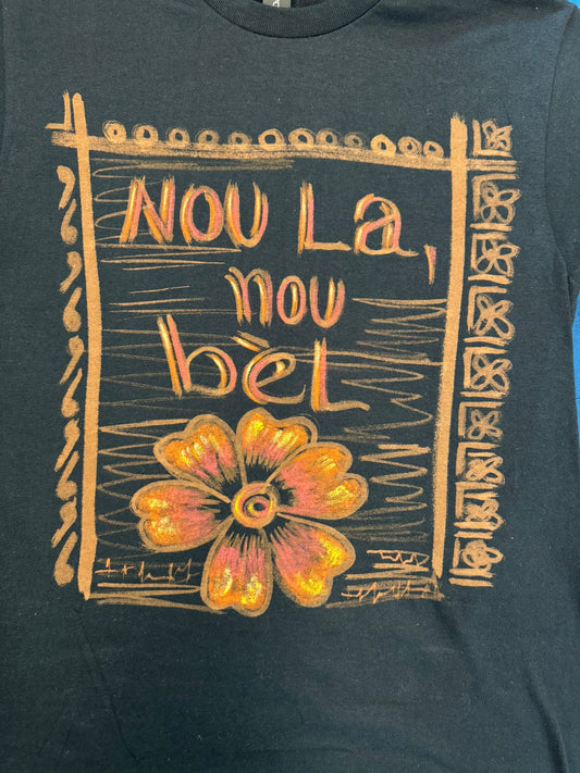 Nou la, Nou bèl. ( we are present, and beautiful).